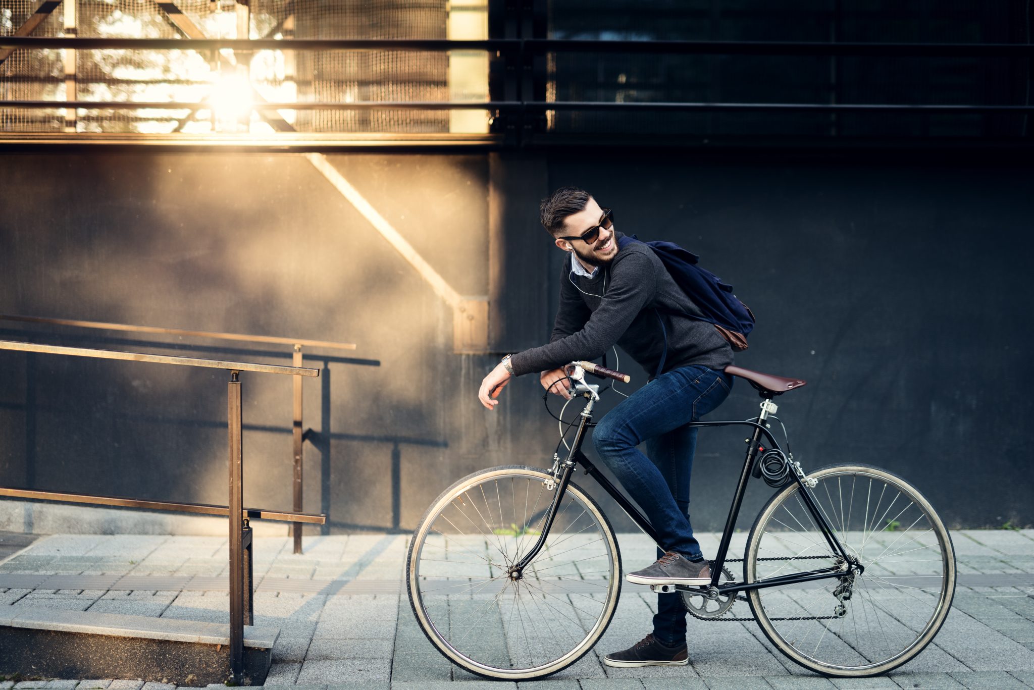 A Young Stylish Businessman Going To Work By Bike